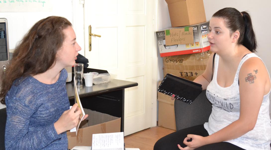 Teenage volunteer chat with each other about different interview techniques during their Journalism Project Journalism volunteers practice their interviewing skills as part of their project in Romania